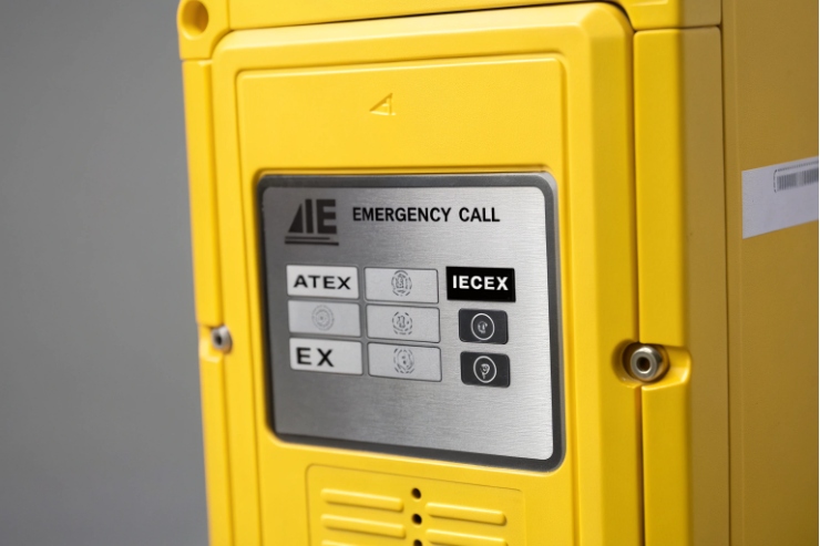 Close-up of yellow emergency call panel showing ATEX and IECEx markings