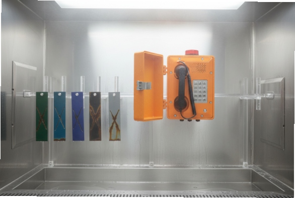 Open SIP emergency phone in corrosion test chamber with coated sample panels