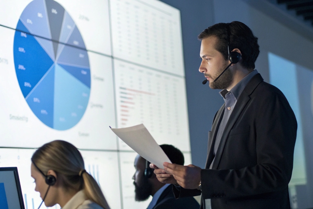 Business professionals reviewing data and graphs in a call center