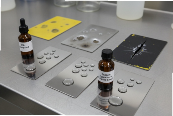 Chemical resistance test samples showing disinfectants affecting coatings and surface integrity
