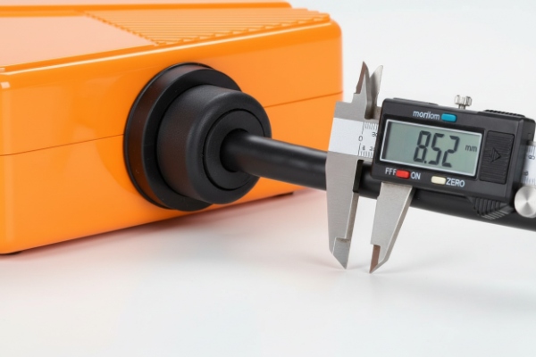 Digital caliper measuring cable diameter at waterproof grommet on SIP intercom enclosure