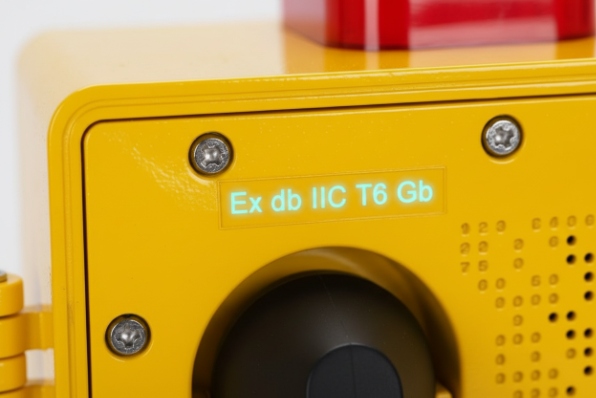 Close-up of yellow device showing Ex db IIC T6 Gb marking on explosion-proof enclosure