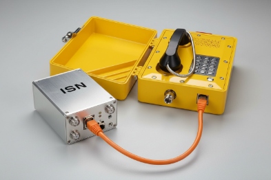 Industrial emergency phone connected to ISN test box with orange Ethernet cable