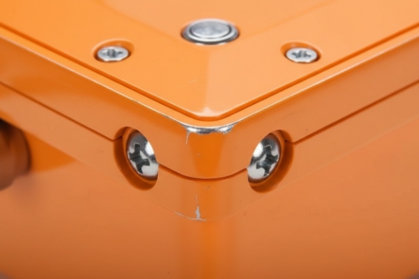 Close-up of reinforced enclosure corner with security screws on waterproof SIP telephone