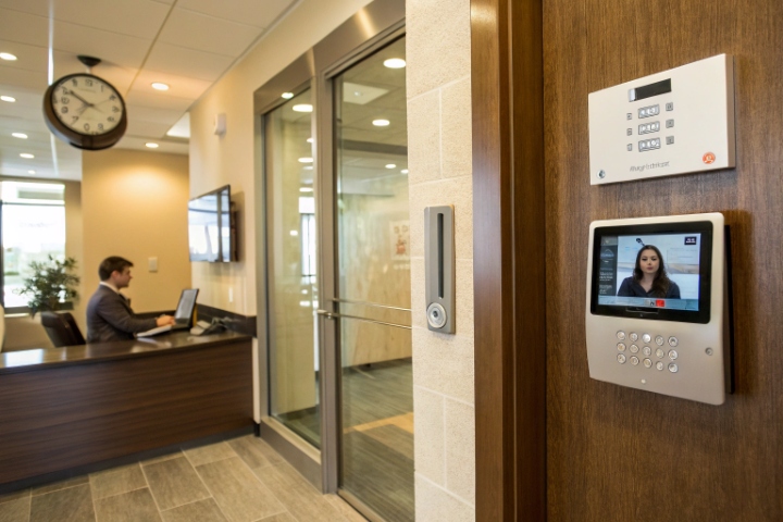 Office lobby with wall mounted video intercom keypad and access control devices