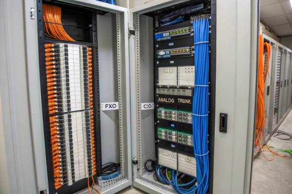 FXO gateway rack with analog trunk cabling in telecom room