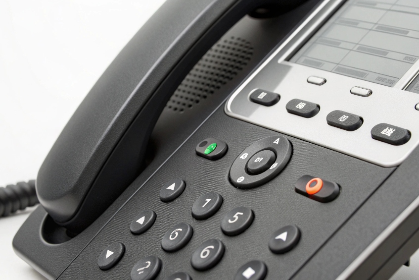 Close up of VoIP desk phone keypad navigation buttons and status indicators