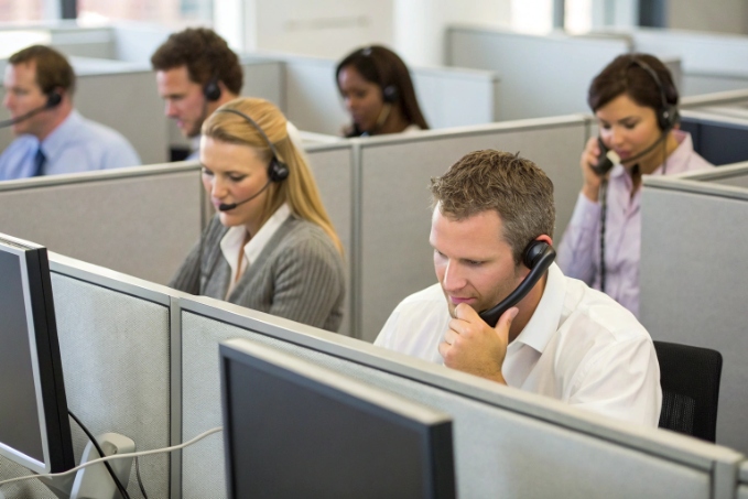 Busy contact center agents handling customer support calls on headsets