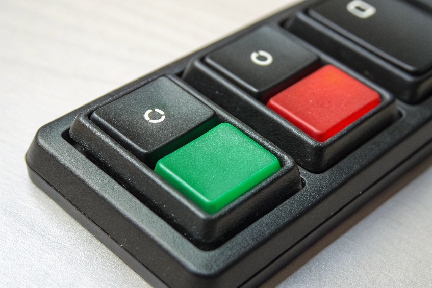Close-up of small control panel with green and red call control buttons
